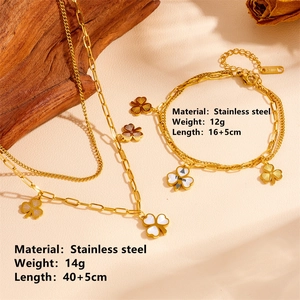 Double-layer golden clover necklace and bracelet set in stainless steel with white enamel