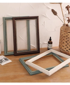 Detail of vintage European oil painting frames with gold beaded accents and wood grain