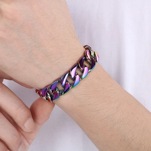 Detail of 15mm rainbow colored stainless steel Cuban chain bracelet on male wrist