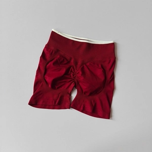 Detail of burgundy seamless yoga shorts showing high-waisted band and scrunch butt design