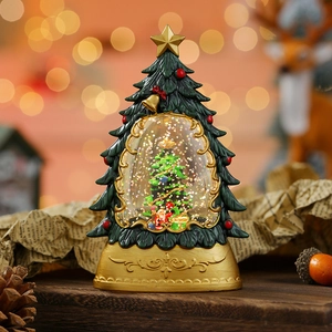 Detailed view of a Christmas tree snow globe with a gold base on a rustic wooden table
