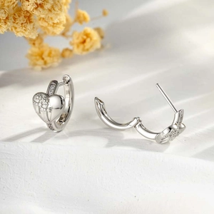 Silver heart-shaped hoop earrings with floral texture and sparkling cubic zirconia stones