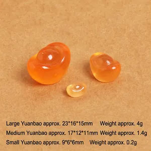 Detailed view of three translucent orange resin gold ingots in various sizes