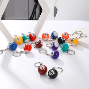 Close-up of colorful resin billiard ball keychains showing glossy finish and metal ring