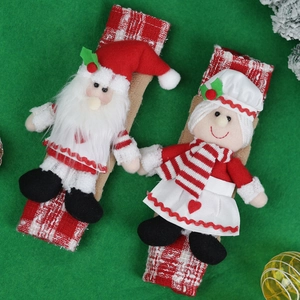 Christmas microwave handle covers with Santa and girl figures on a green background
