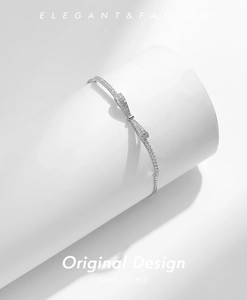 Close-up of S925 sterling silver bow bracelet with pavé cubic zirconia on display stand