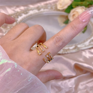 Detailed shot of a gold-plated triple-layer ring with sparkling cubic zirconia on a model