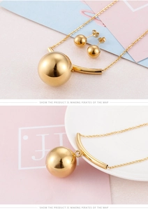 Detailed view of golden bead necklace and earrings set with modern curved metal bars