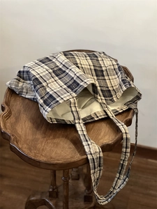 Detailed view of British style quilted plaid cotton tote bag with soft diamond texture