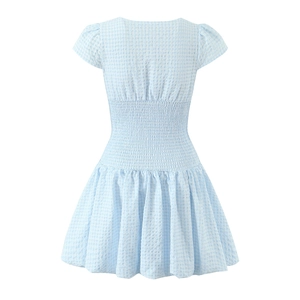 Detailed back view of light blue plaid dress showing smocked waist and seersucker texture