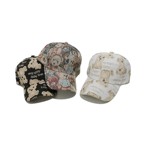 Three teddy bear baseball caps in black and cream featuring cute jacquard patterns