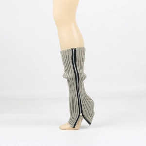 Detail view of grey ribbed knit leg warmers featuring a stylish side zipper and metal puller