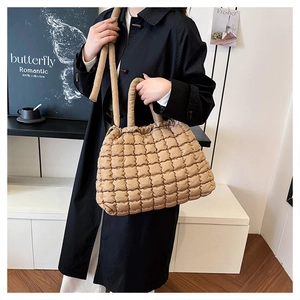 Quilted tote bag in khaki finish showing puffer texture and stylish shoulder straps