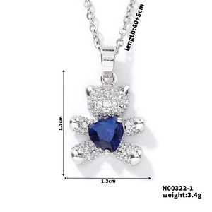Detail shot of silver bear pendant with blue heart gem and 1.7x1.3cm size specs
