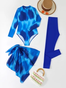 Flat lay detail of blue tie-dye long sleeve three-piece swimsuit with matching leggings