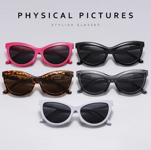 Selection of cat eye sunglasses in pink, black, tortoiseshell, gray, and white colors
