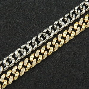 Close-up of gold and silver Miami Cuban link bracelets with sparkling diamond inlay
