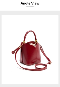 Detail of red petal-shaped bucket bag with beige drawstring pouch and gold hardware