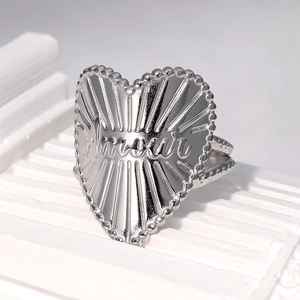 Close-up of Amour engraved heart ring with radiant texture and beaded silver edges