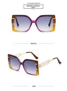 Detail view of square oversized sunglasses featuring purple-brown gradient frame and gold temples