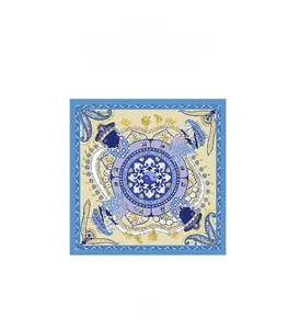 Detailed view of the square silk scarf featuring a blue and yellow paisley mandala pattern