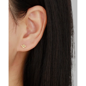 Elegant gold flower cluster stud earring with clear zircon diamonds on female earlobe