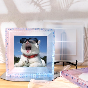 Close-up of DIY silicone photo frame mold with a finished glitter resin cat frame