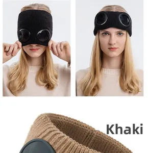 Detail of knitted earband featuring integrated goggles in khaki and black color options