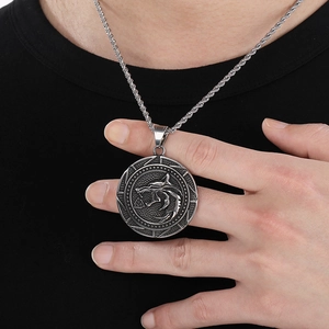 Detail of Viking wolf head pendant with Valknut symbol on a silver stainless steel necklace