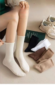 Detailed close-up of ribbed texture and elastic cuff on multi-color cotton crew socks