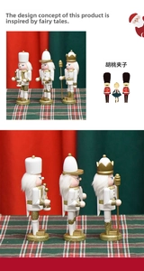 Detailed view of white and gold wooden nutcracker soldier ornaments with glitter finish