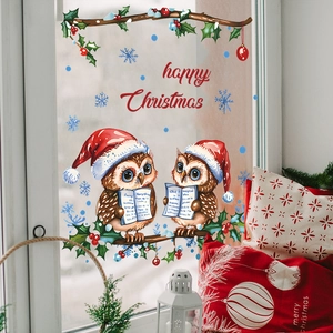 Detail of Christmas window stickers featuring owls with santa hats and snowy branches