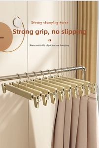 Detail of matte seamless pants hanger showing strong anti-slip clips and adjustable metal bar