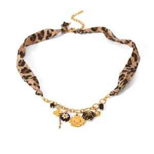Detail of leopard print fabric collar with gold flower charms and daisy pendants