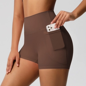 Detail of high-waisted coffee sports shorts featuring functional side phone pockets
