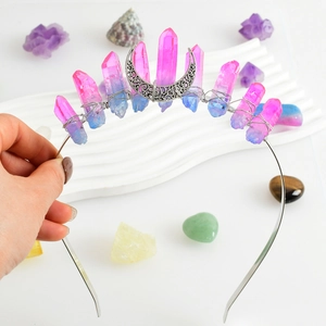 Detail of handmade crystal crown with raw pink-blue pillars and silver crescent moon