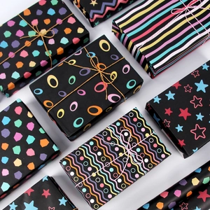 Colorful geometric patterns on black striped gift wrapping paper for birthdays and festivals