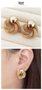 Detail of vintage 18K gold plated woven knot earrings with textured mesh and smooth stud
