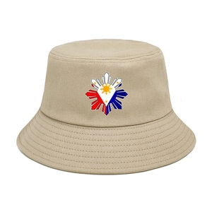 Detail of khaki cotton bucket hat featuring a colorful Philippine flag sun and stars emblem
