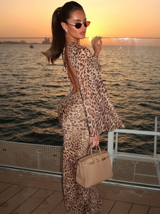Detail of the backless leopard print dress featuring elegant bell sleeves and tie closure