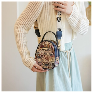 Detail of printed crossbody bag with Teddy bear motif and branded wide shoulder strap