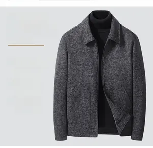 Detail of dark grey textured wool jacket featuring a lapel collar and metal zipper closure