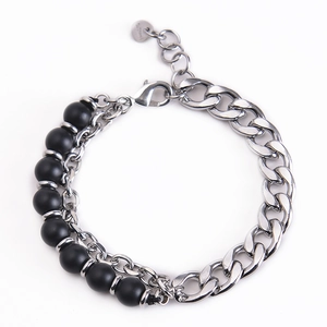 Detail of double-layer men's bracelet with black natural stone beads and silver chain