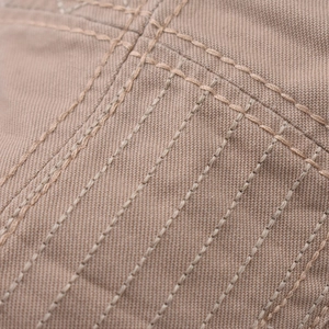 Close-up of khaki canvas beret with parallel reinforced stitching and durable texture
