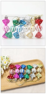 Detail view of 6 colorful Christmas candy ornaments with glitter stripes on a wood tray