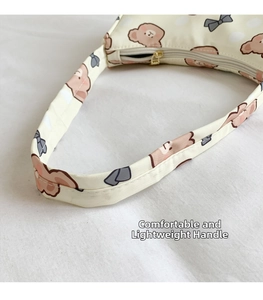 Detail of comfortable lightweight handle on cream canvas bag with cute bear print