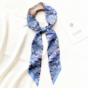 Detail showing silky narrow scarf with blue wave patterns and seagull print details