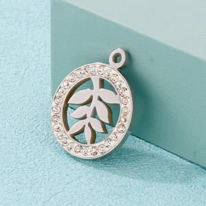 Silver stainless steel leaf pendant with rhinestones on a minimalist background