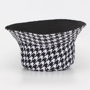 Close-up of the black and white houndstooth pattern texture on the bucket hat