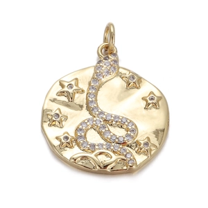 Macro shot of gold hammered medallion pendant with crystal snake and stars detail